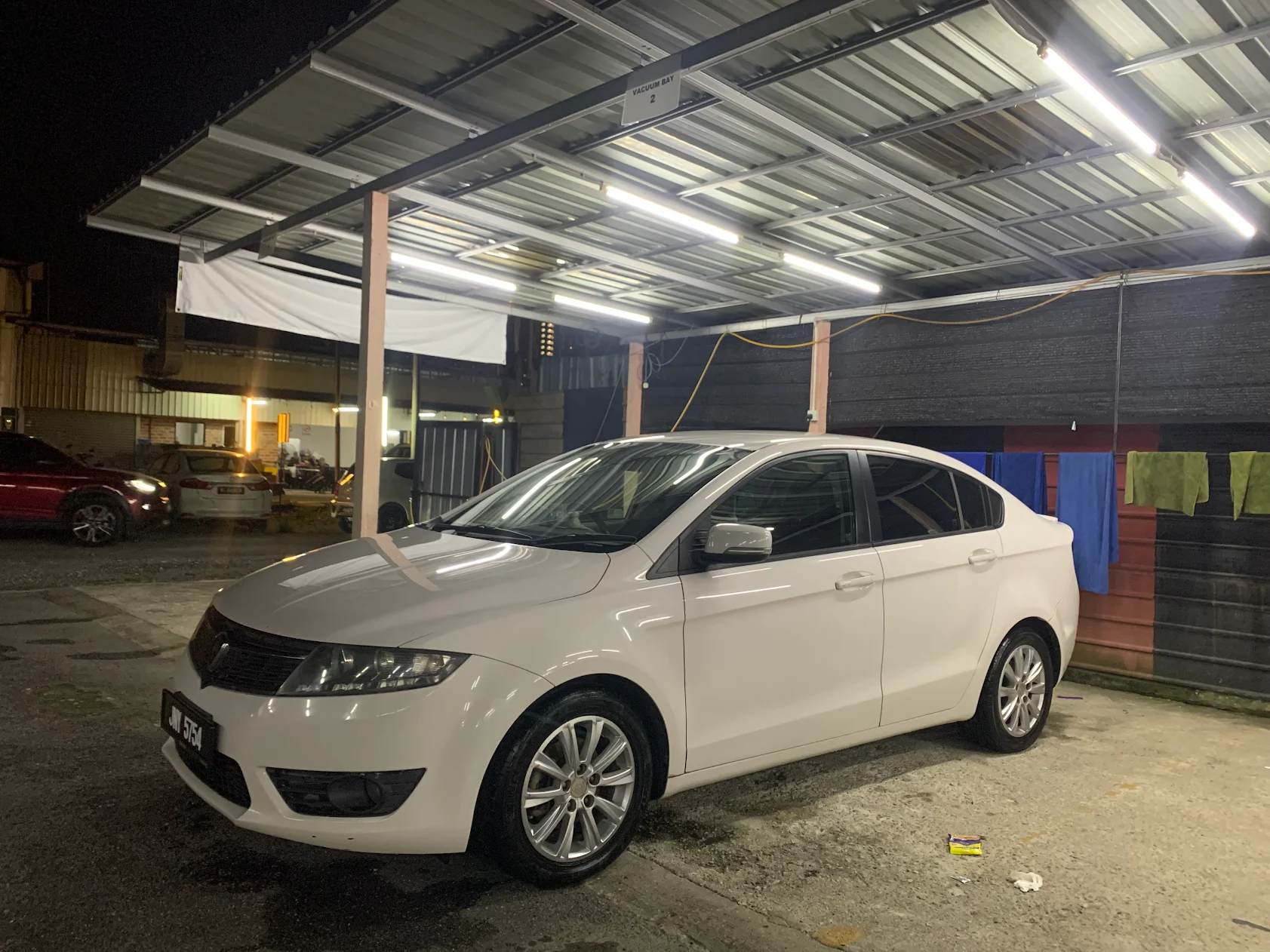White sedan exterior after car wash service